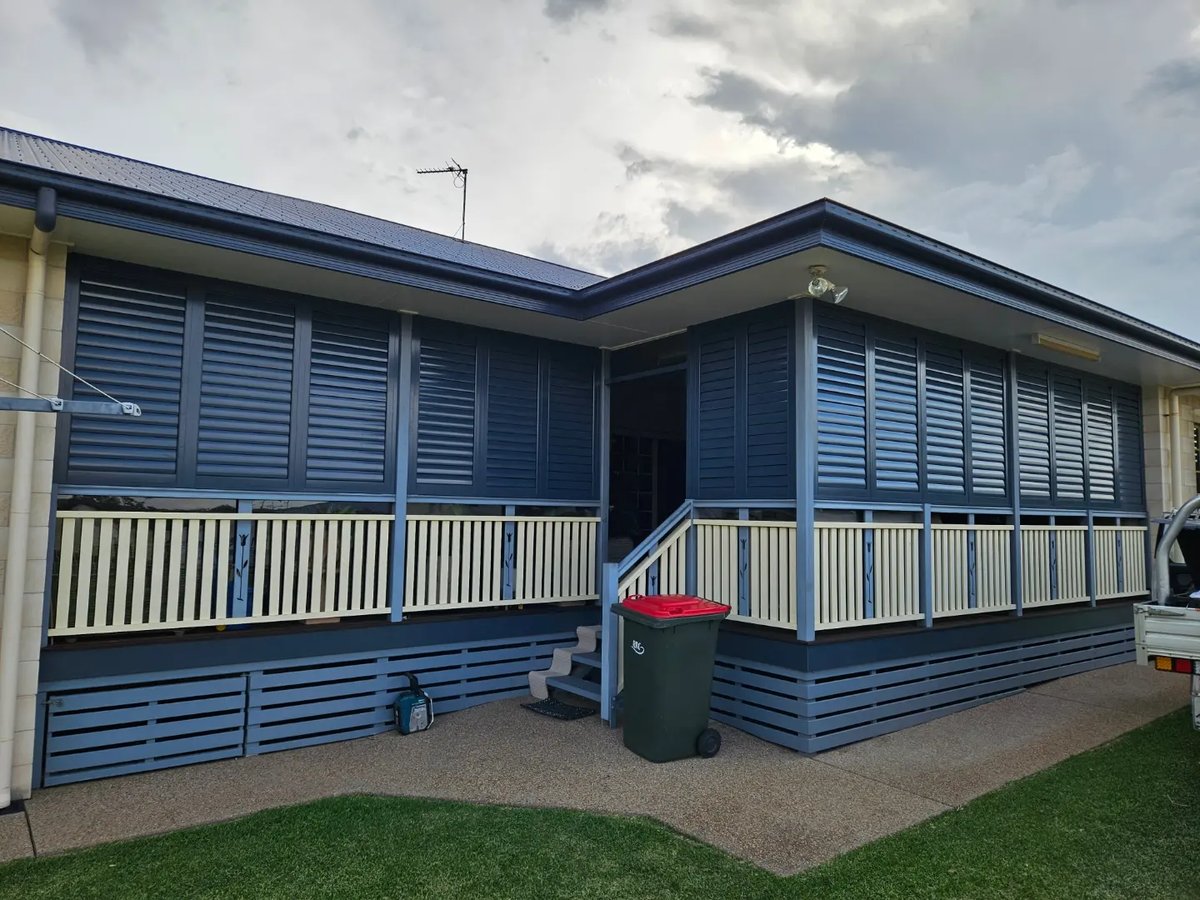 Blue Queenslander verandah fully enclosed in external shutters