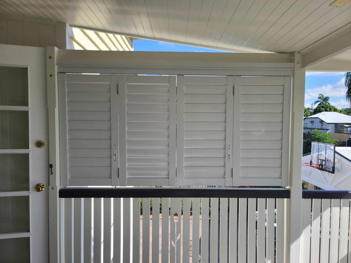 White shutters above a verandah balustrade on a Queenslander